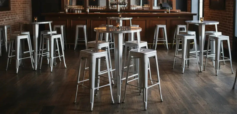 Bar area with stools and tables in a rustic setting
