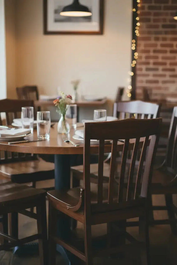 Dining area with wooden tables and chairs, blurred background